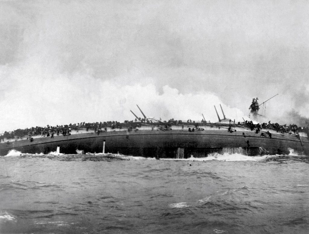 Black and white photograph of a Blucher warship capsizing. 